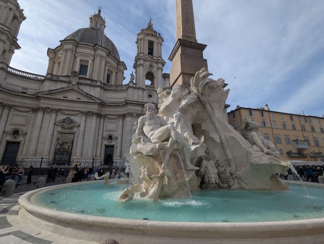 The Fontana dei Quattro Fiumi (Fountain of the Four Rivers) in Piazza Navona, Rome, Italy, a Baroque fountain featuring an obelisk, statues representing the rivers Danube, Nile, Ganges, and Río de la Plata, and the church of Sant'Agnese in Agone in the background.